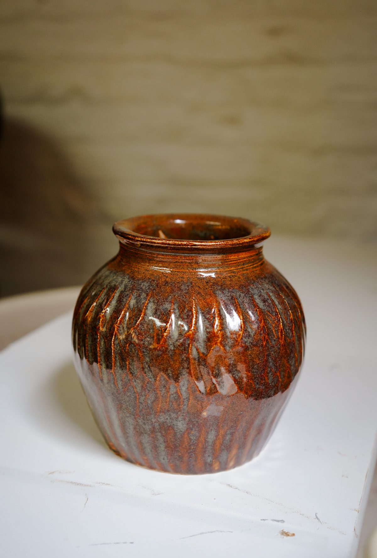A finished, amber-glazed stoneware jar made at Claymore