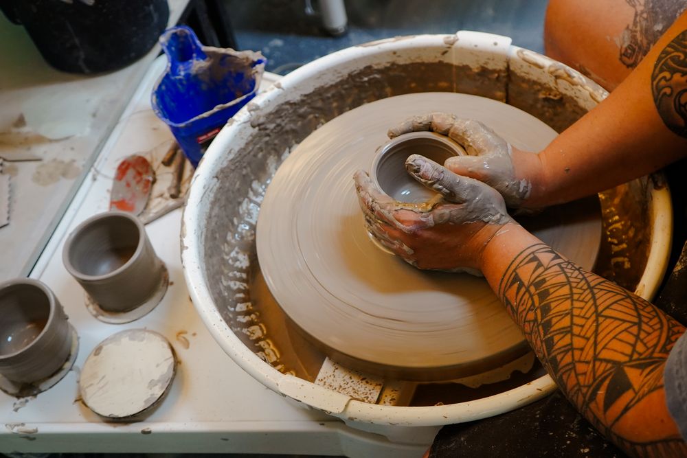 Tools and freshly thrown pieces resting on the wheel