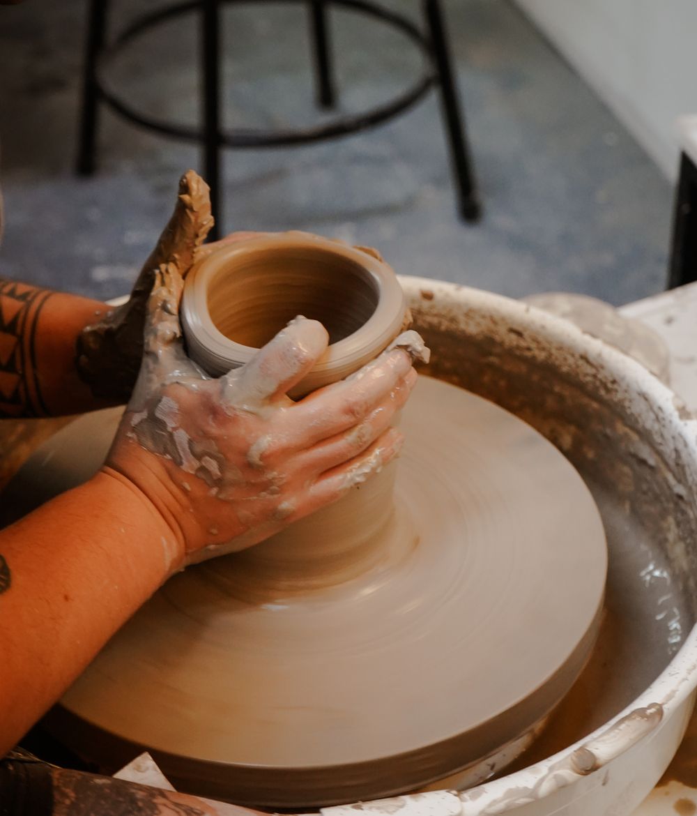 A member throwing a mug at the wheel