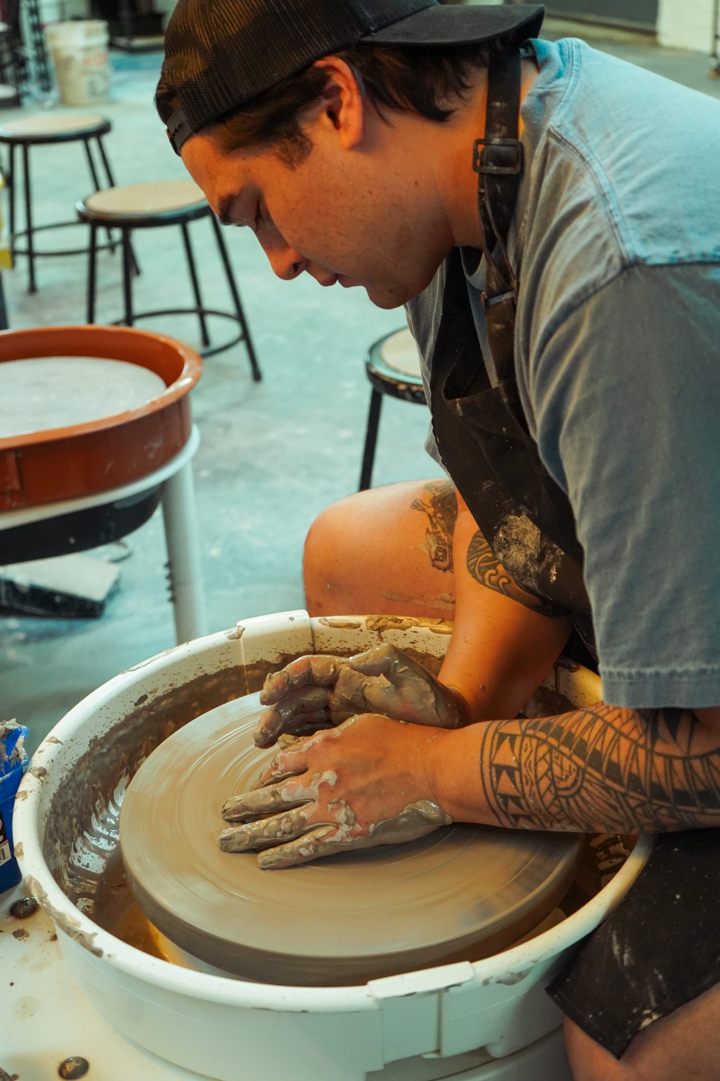 A member at work at the wheel in the studio