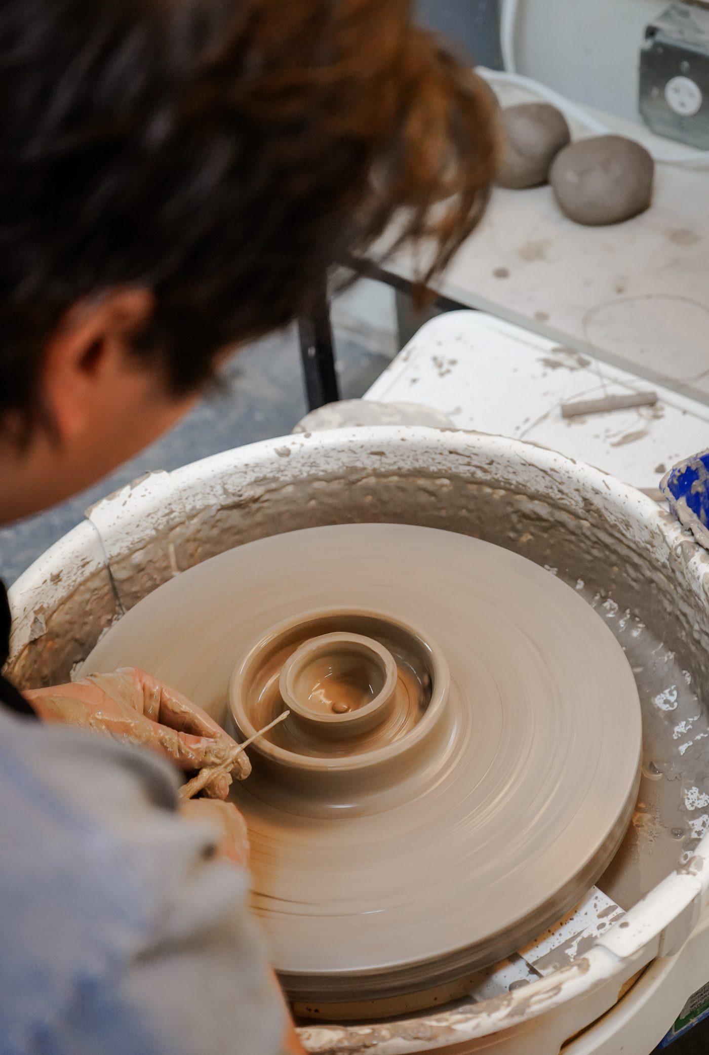 Trimming a leather-hard pot on the wheel